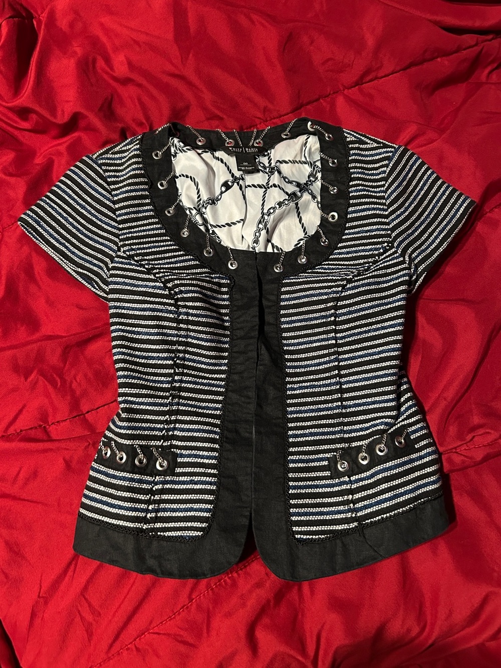 Black, white, dark blue striped fitted top with metal chain linked grommets